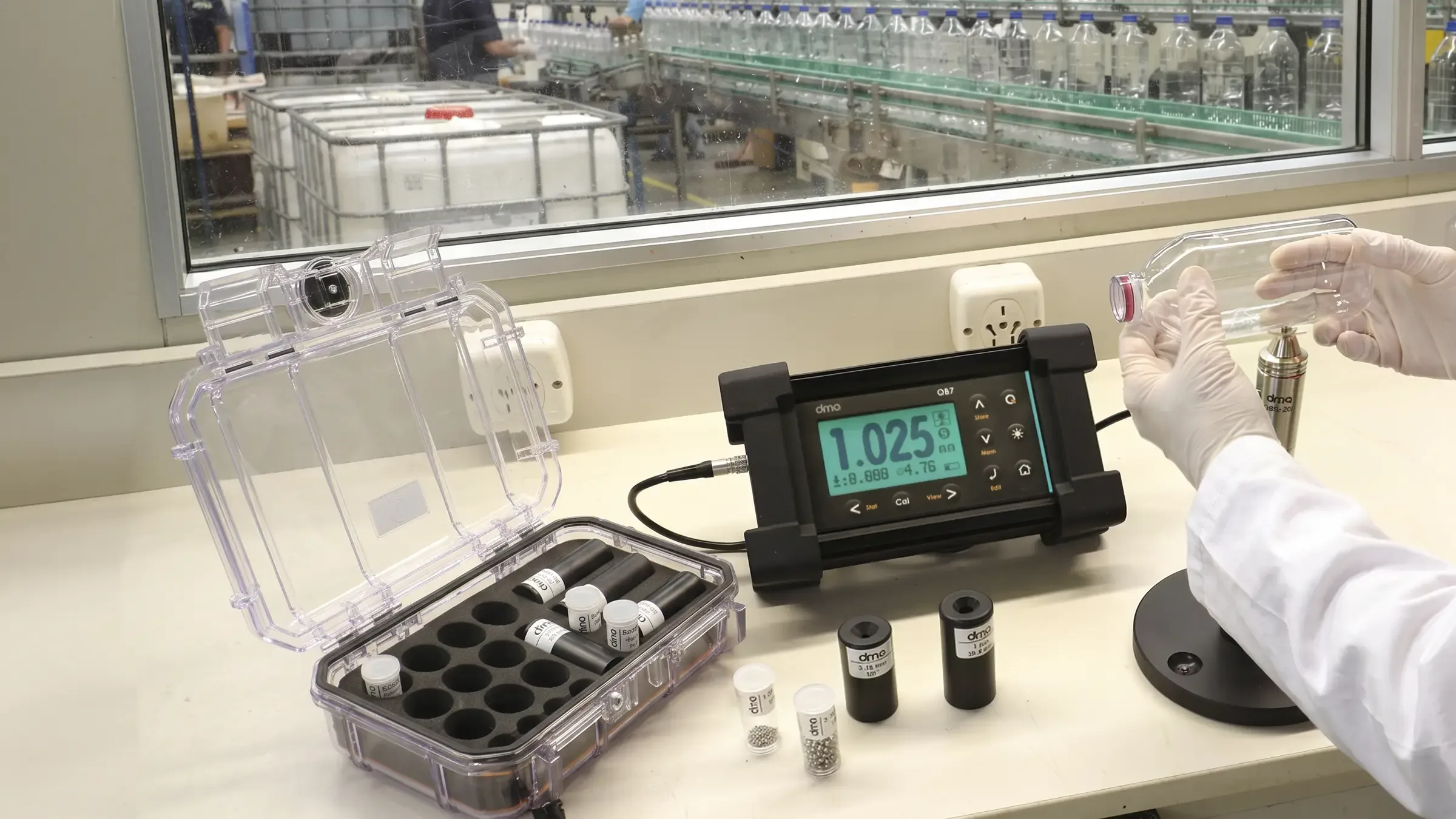 QB7 Hall effect thickness gauge measuring a bottle on a bottling line
